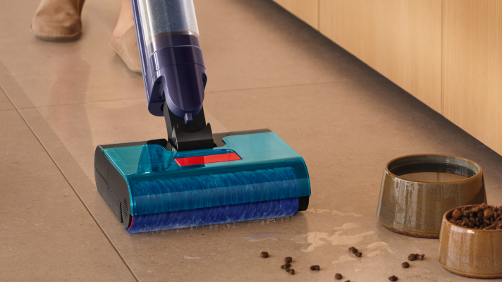Dyson wet and dry vacuum cleaner is used to clean a pill on the tile floor.